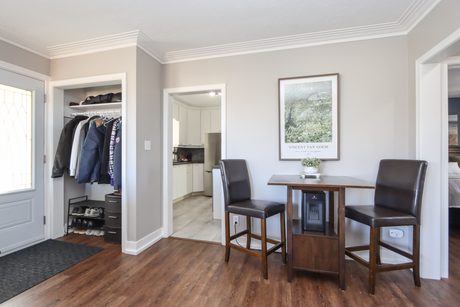 Dining area by the front entry with wood-tone floors