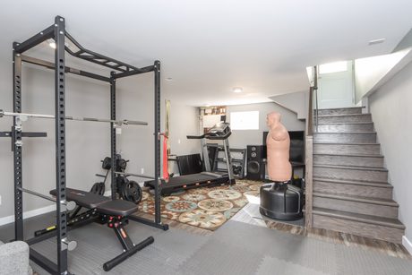 Lower-level rec room set up as a home gym