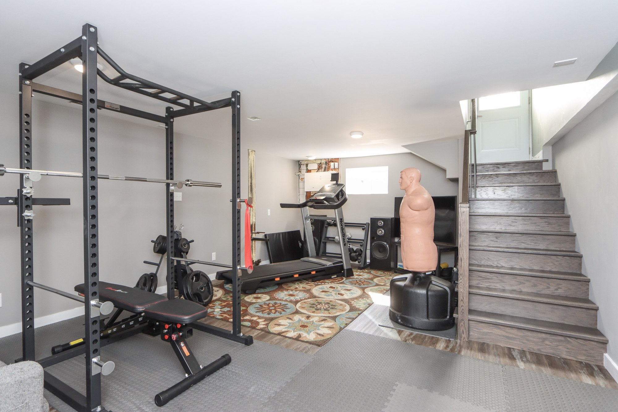Lower-level rec room set up as a home gym