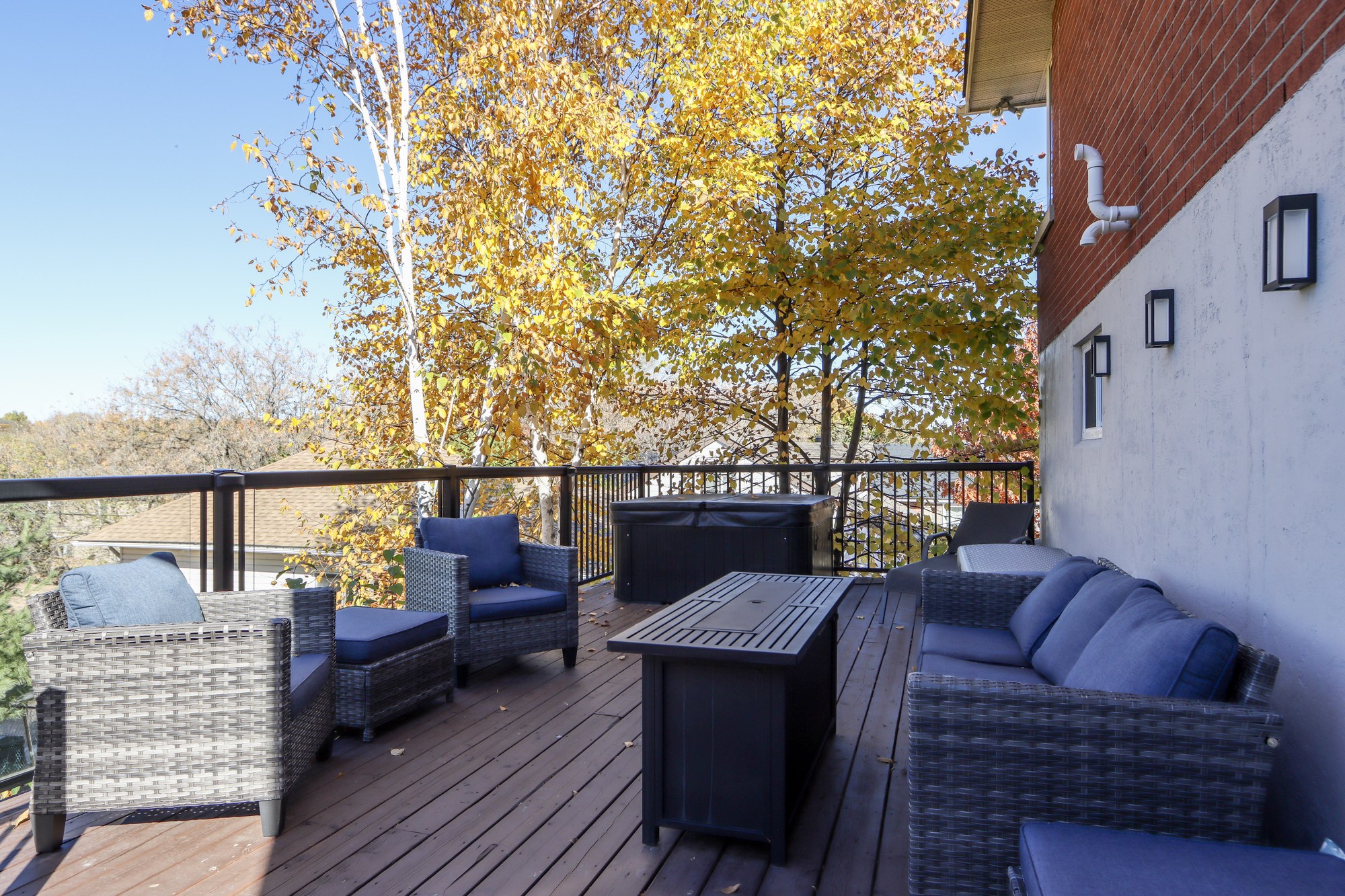 Back deck with outdoor seating and a treetop view