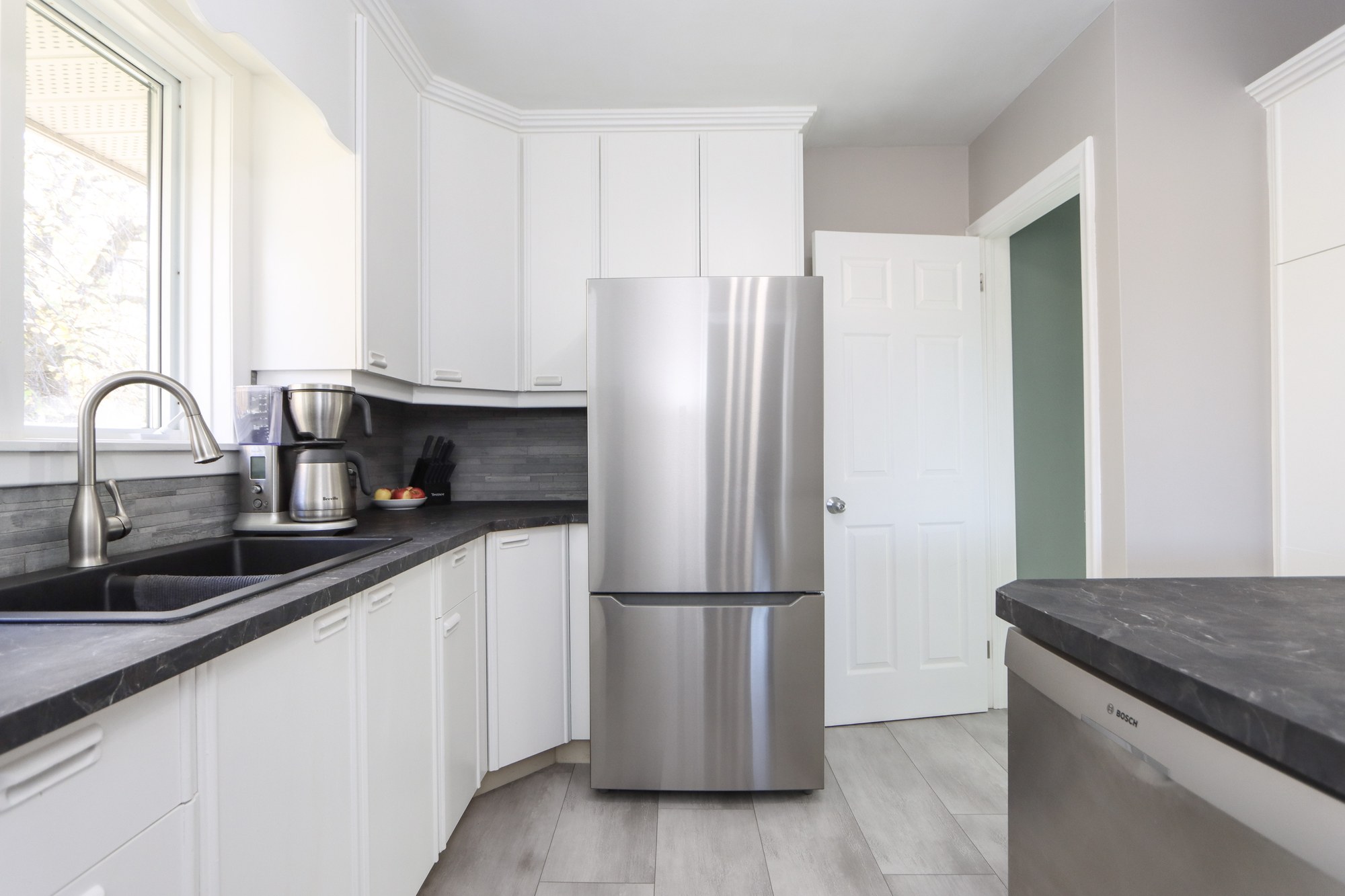 Kitchen with white cabinetry and stainless appliances