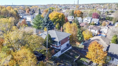 Aerial view of the home and surrounding neighbourhood in autumn