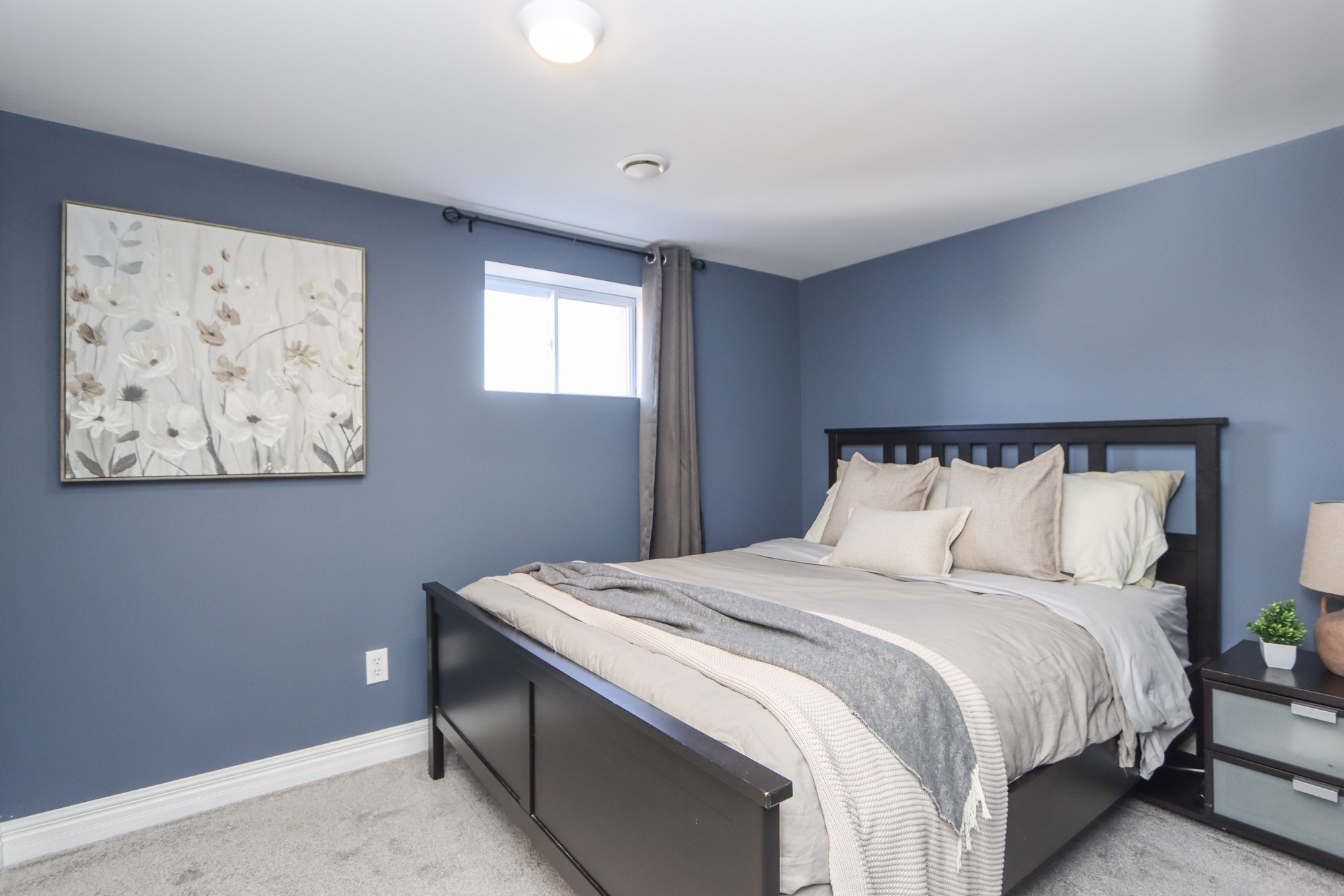 Lower-level bedroom with blue walls